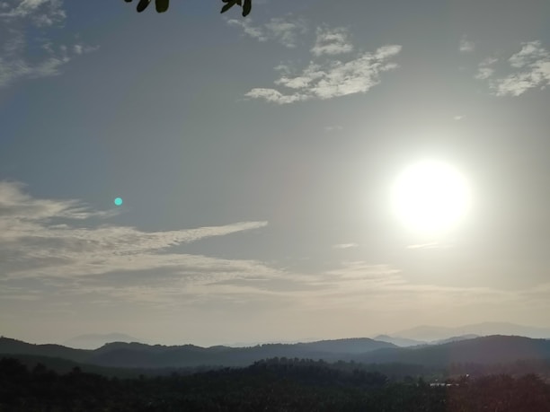 A serene landscape symbolizing new beginnings, with sunlight breaking through the clouds.