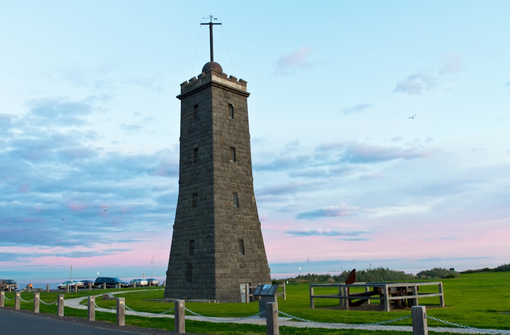 a tall tower with a cross on top of it