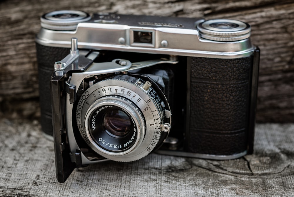 a close up of a camera on a wooden surface