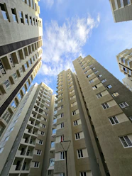 looking up at tall buildings in a city