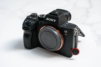 A sleek Sony FX6 camera set against a matte charcoal black backdrop, highlighting its professional design.