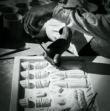 Close-up of a craftsman’s hands carefully polishing a marble slab in a serene workshop.