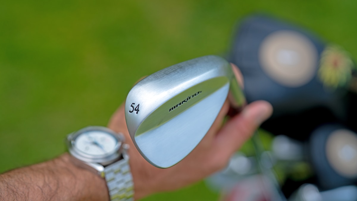 a-person-holding-a-golf-club-in-their-hand-UFCu-7OvFSg collection background image