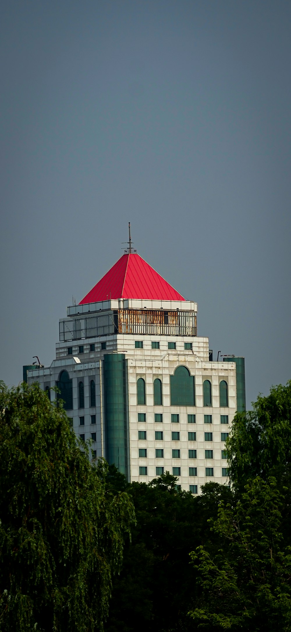 a tall white building with a red roof