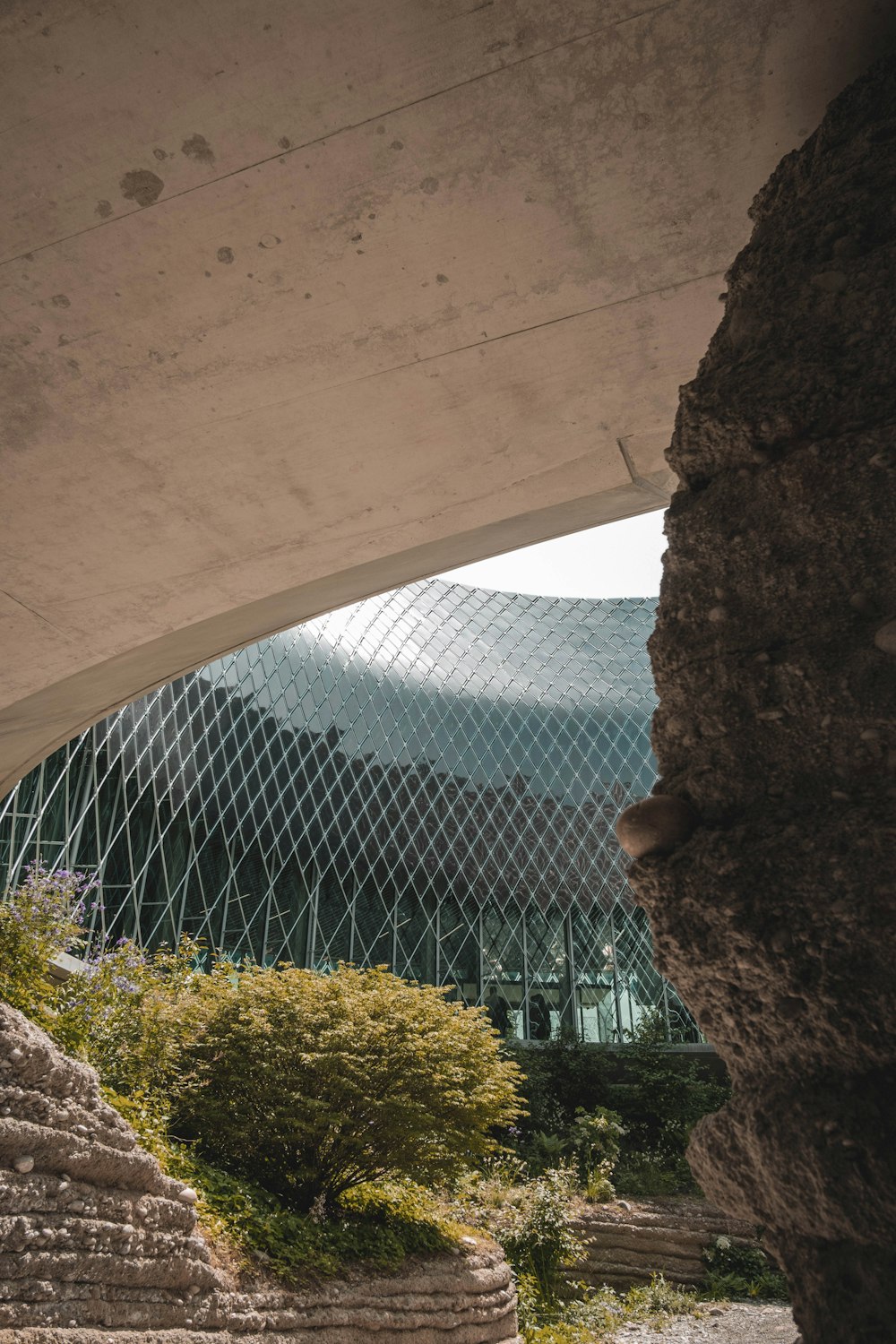 a stone wall and a building with a glass roof