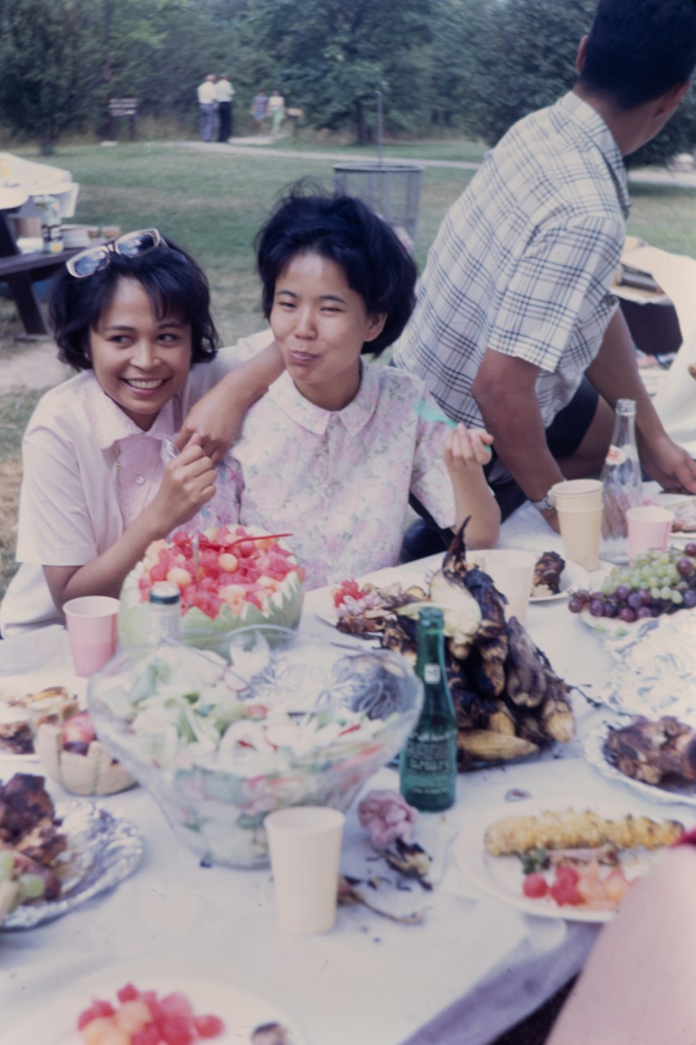 a group of people sitting around a table with food on it