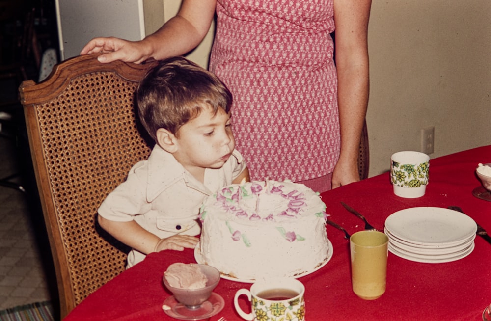 a young boy blowing out the candles on a birthday cake