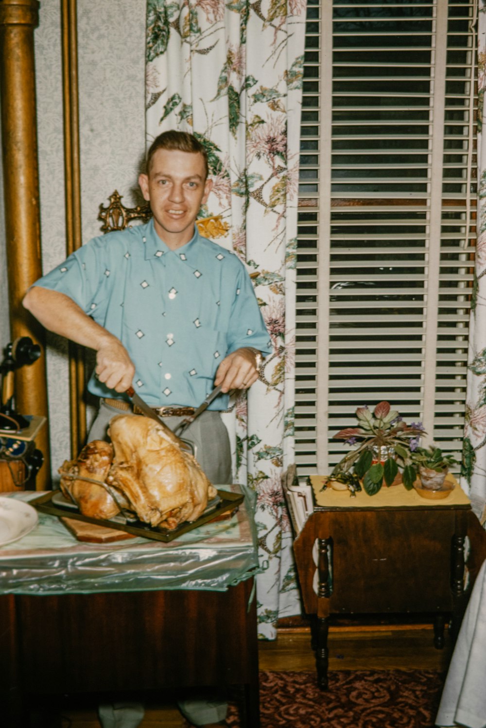 a man standing in front of a turkey on a table
