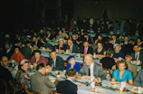 Community members sharing a meal and conversation at a local event.