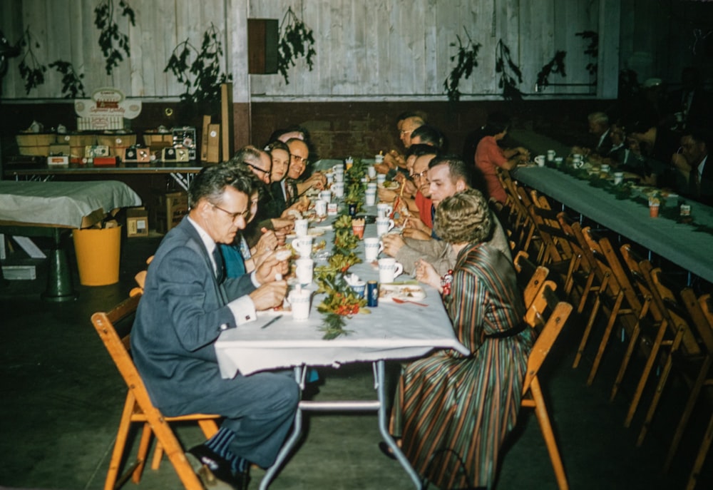 a group of people sitting around a table eating food