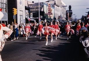 a group of cheerleaders marching down a street