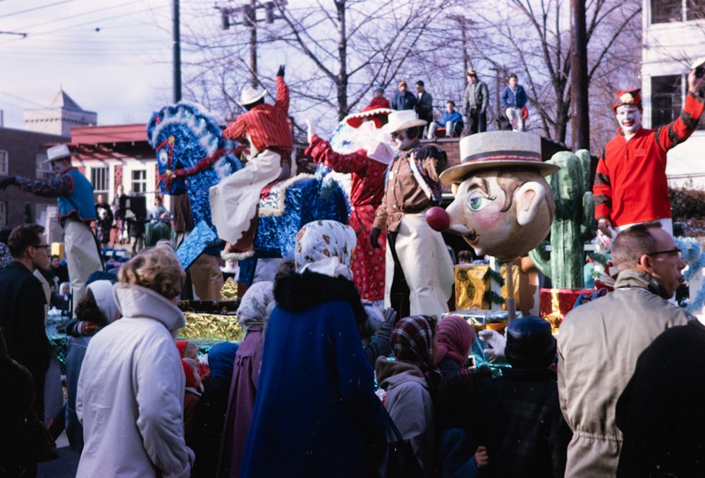 a group of people standing around a float in a parade