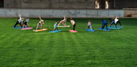 Children happily stretching and playing during a fun yoga session.