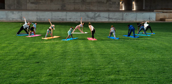 A group of franchise owners and kids practicing yoga together in a bright, welcoming studio.