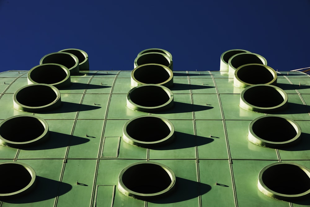 a green building with a bunch of round lights on it