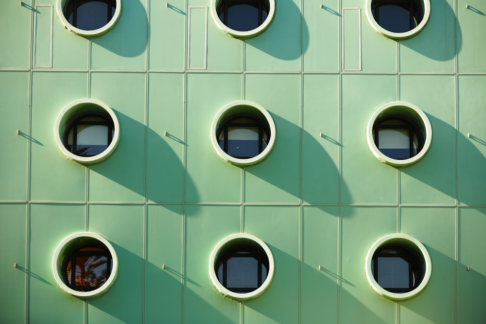 a green building with round windows and round windows