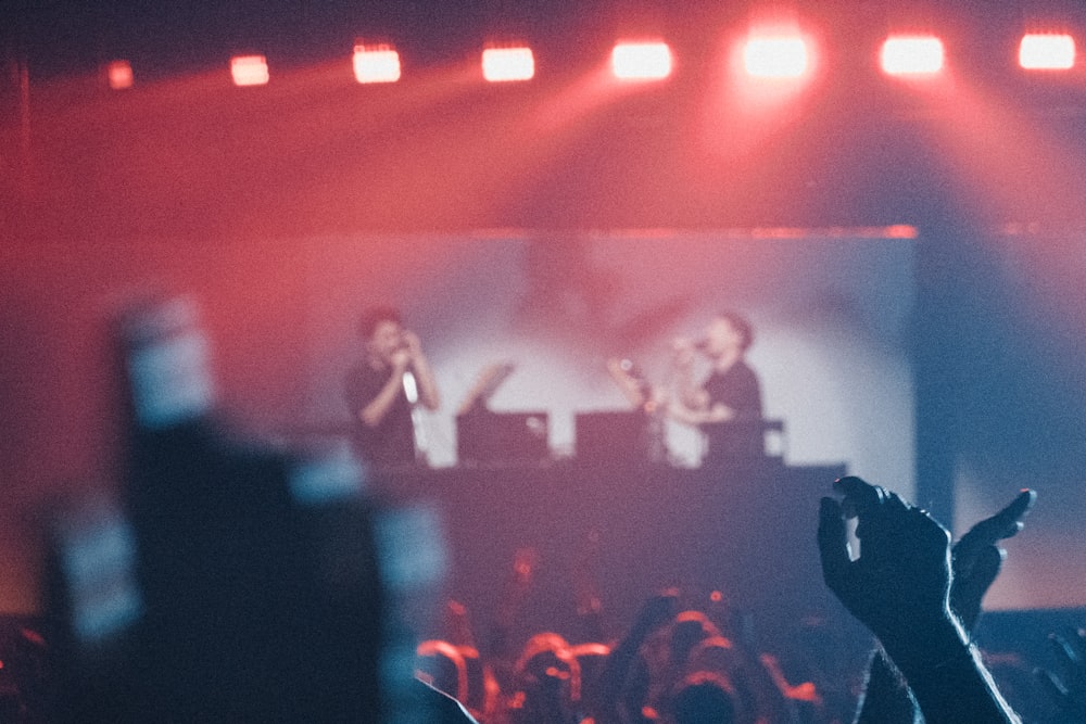 a group of people standing on top of a stage