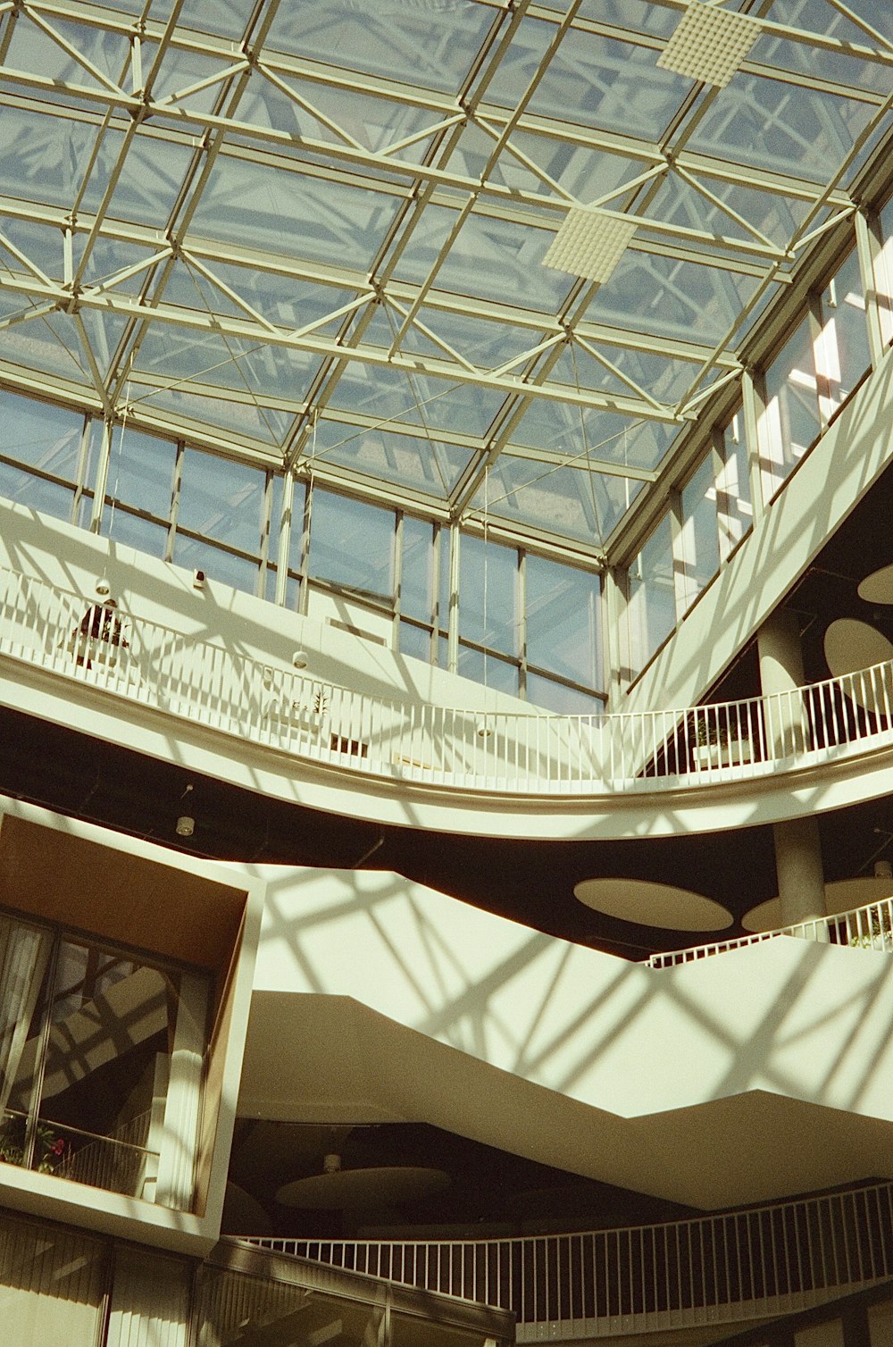 a building with a glass roof and a clock