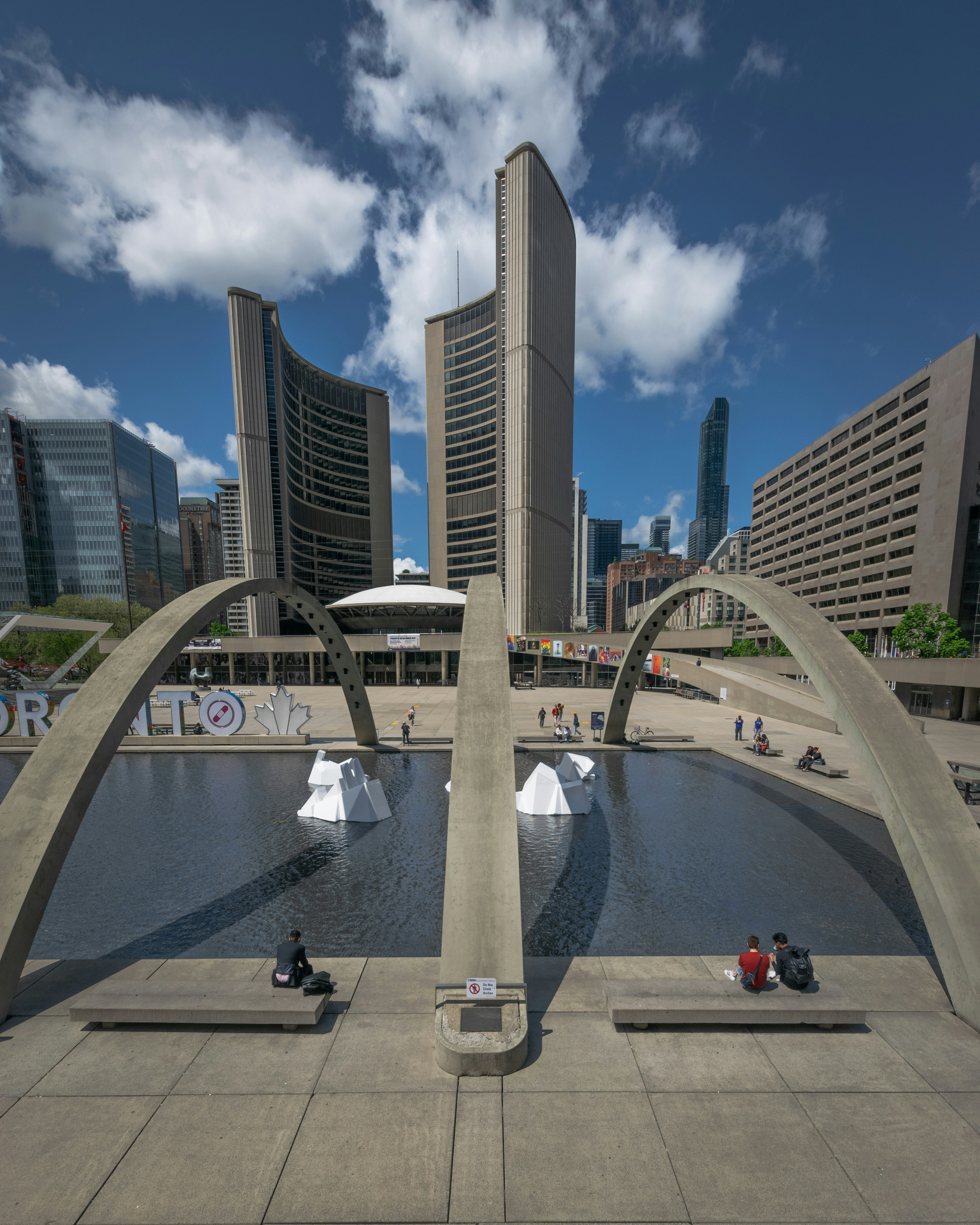 View of Nathan Phillips Square with the Toronto City Hall in the background on a blue sky day. Toronto, Canada, May/22