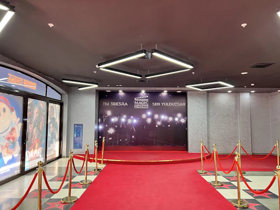 A vibrant collage of popular movie posters and famous celebrities posing on a red carpet.