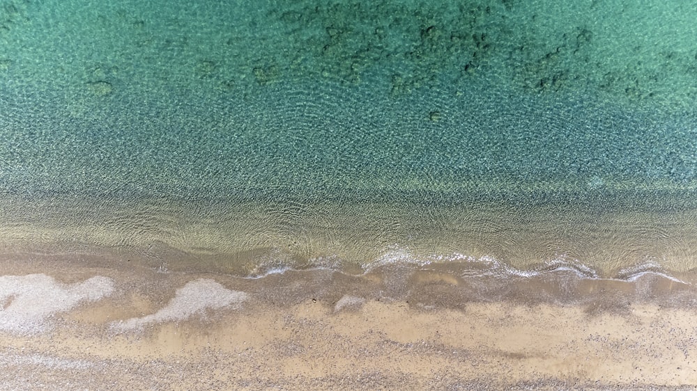 an aerial view of a sandy beach and ocean