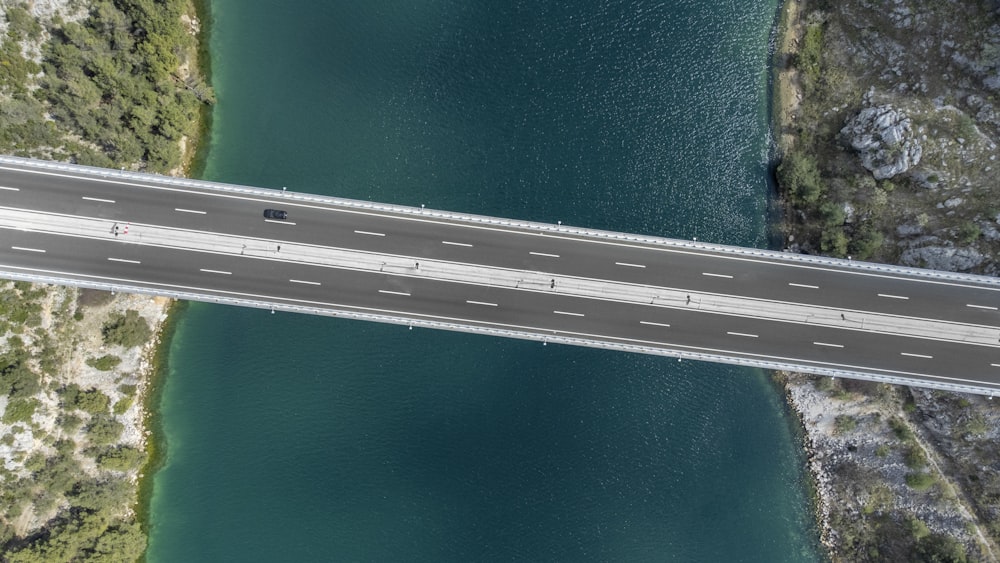 an aerial view of a bridge over a body of water