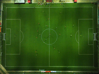 Overhead view of the football animation field with colorful figurines in motion