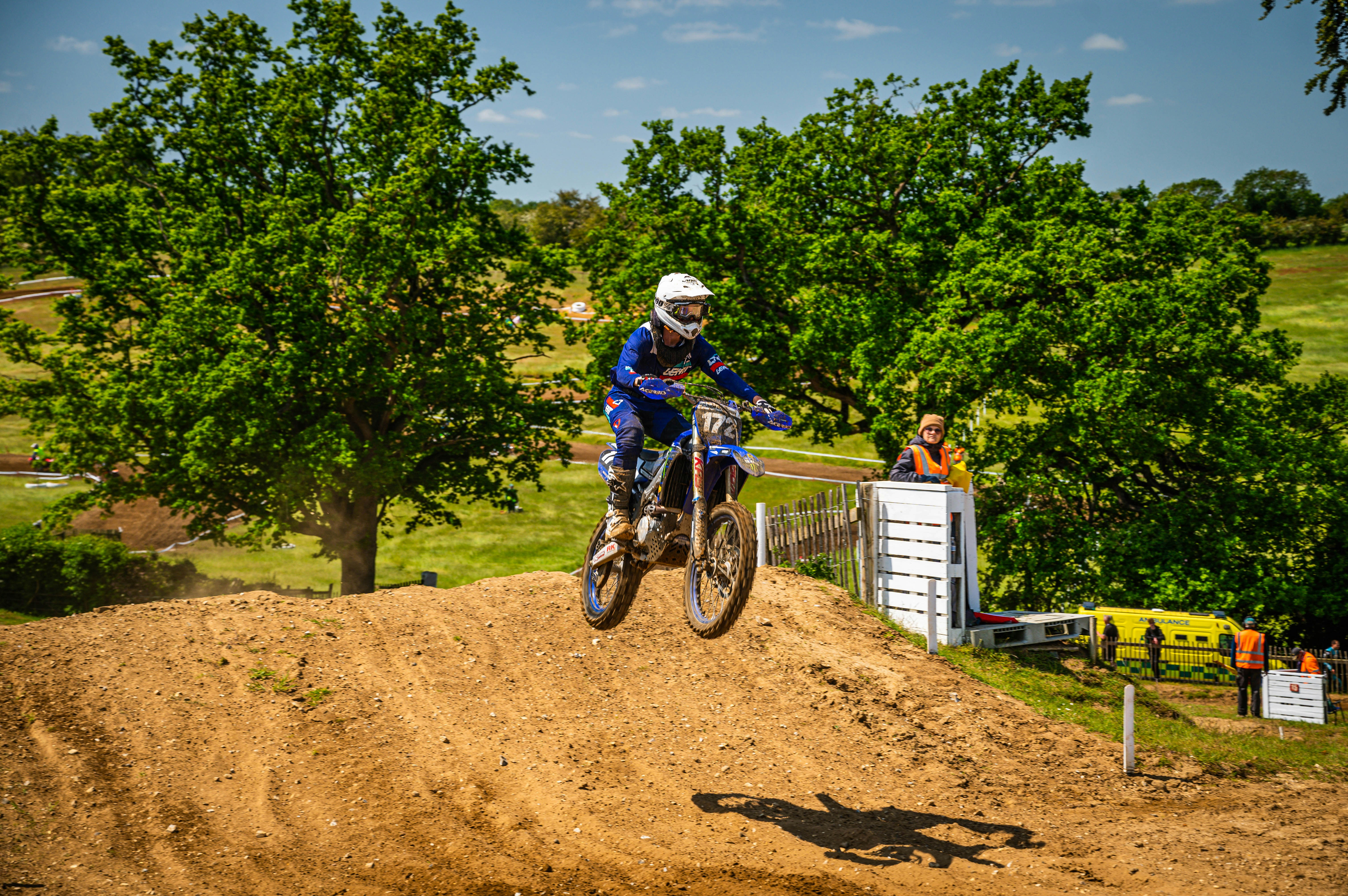 a man riding a dirt bike on top of a dirt hill