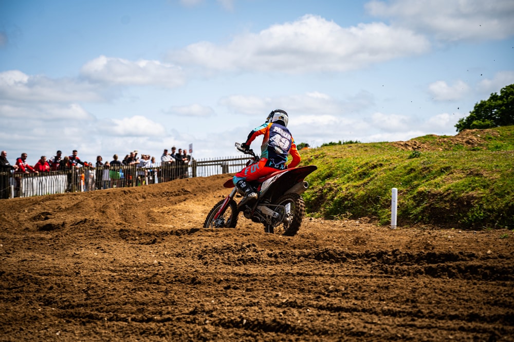 a man riding a dirt bike on top of a dirt field