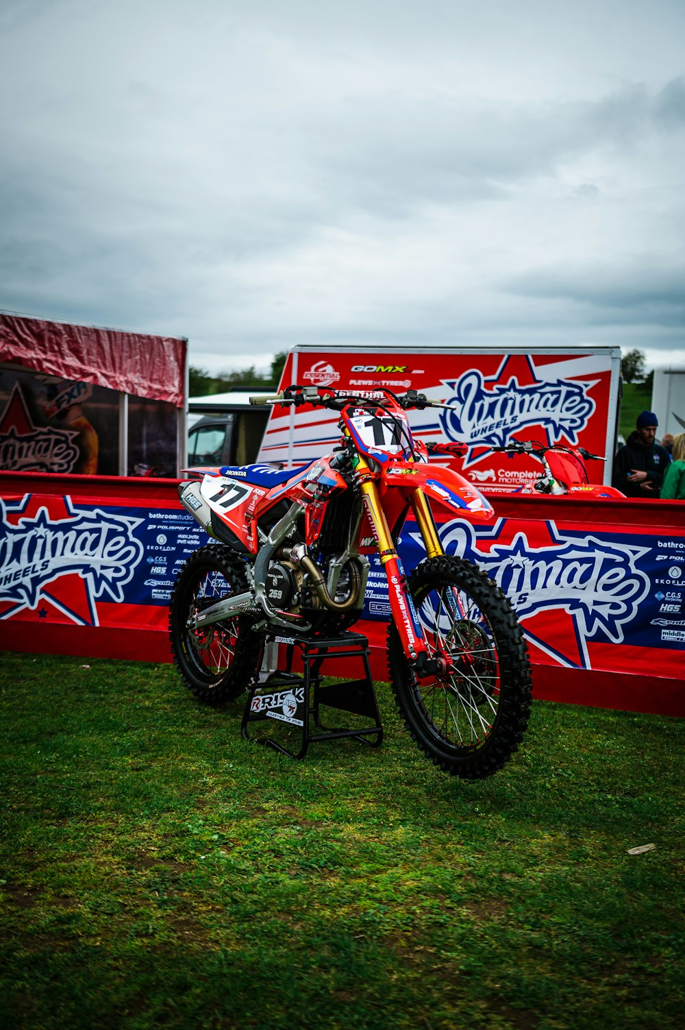 a dirt bike parked on top of a lush green field