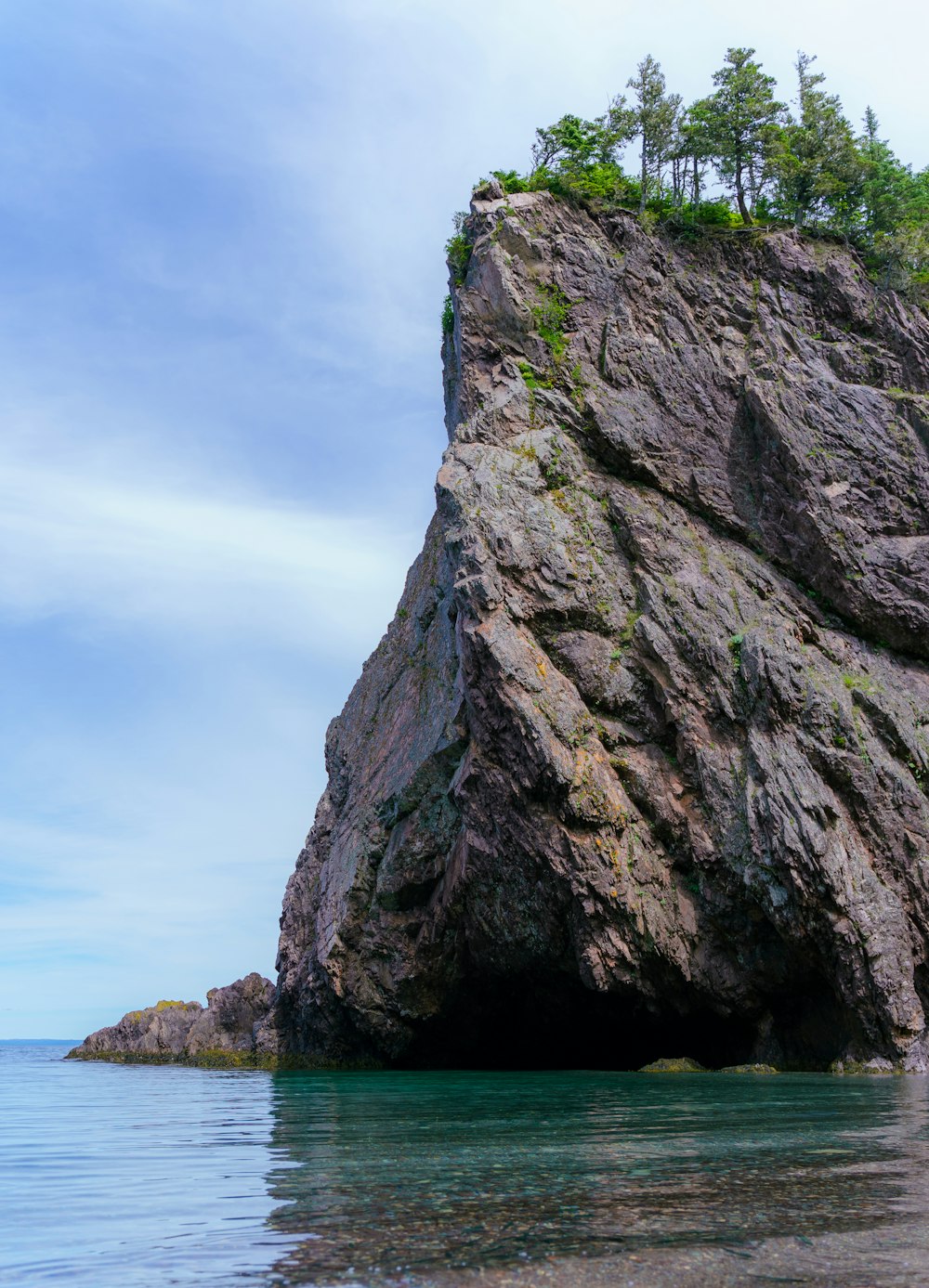 a large rock outcropping into the ocean