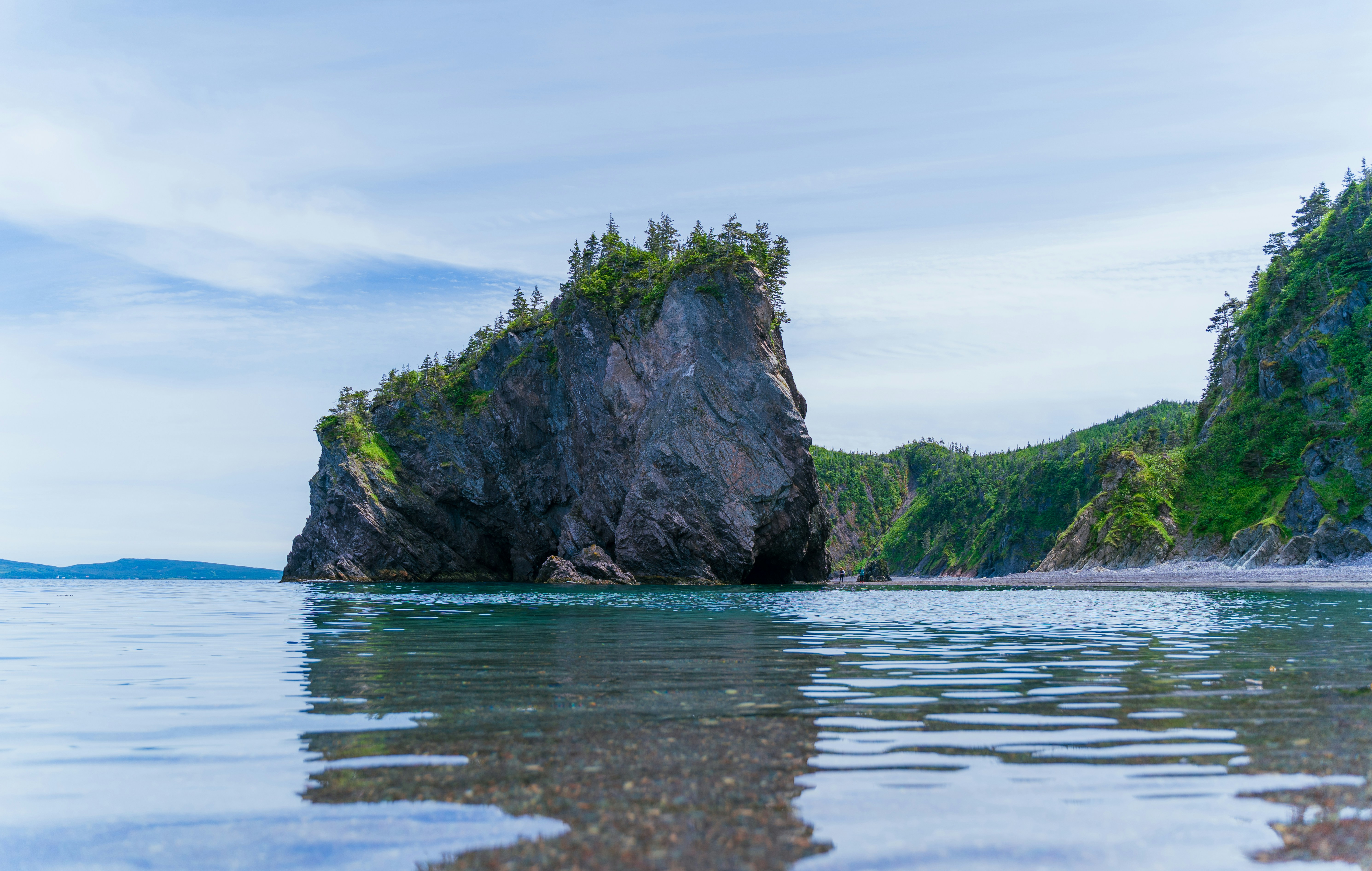 a large rock sticking out of the water