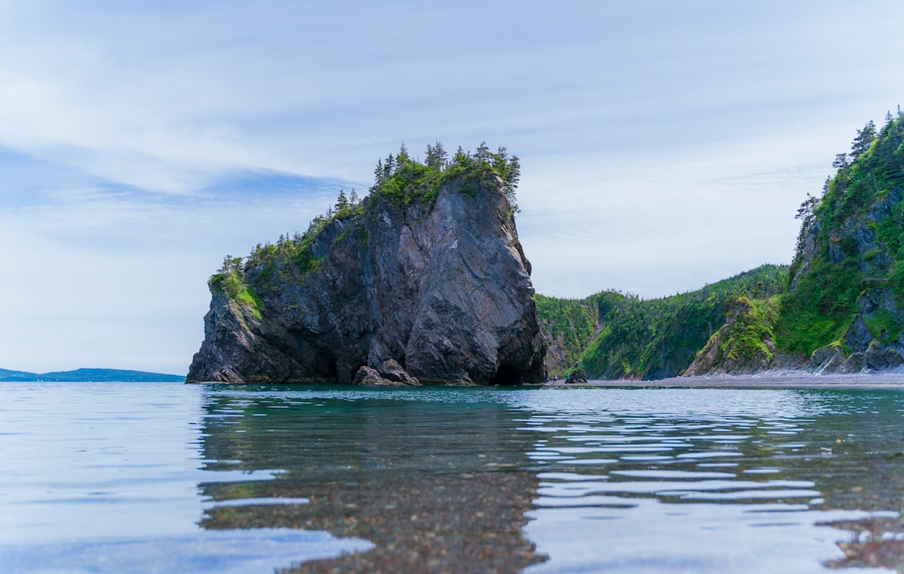 a large rock sticking out of the water