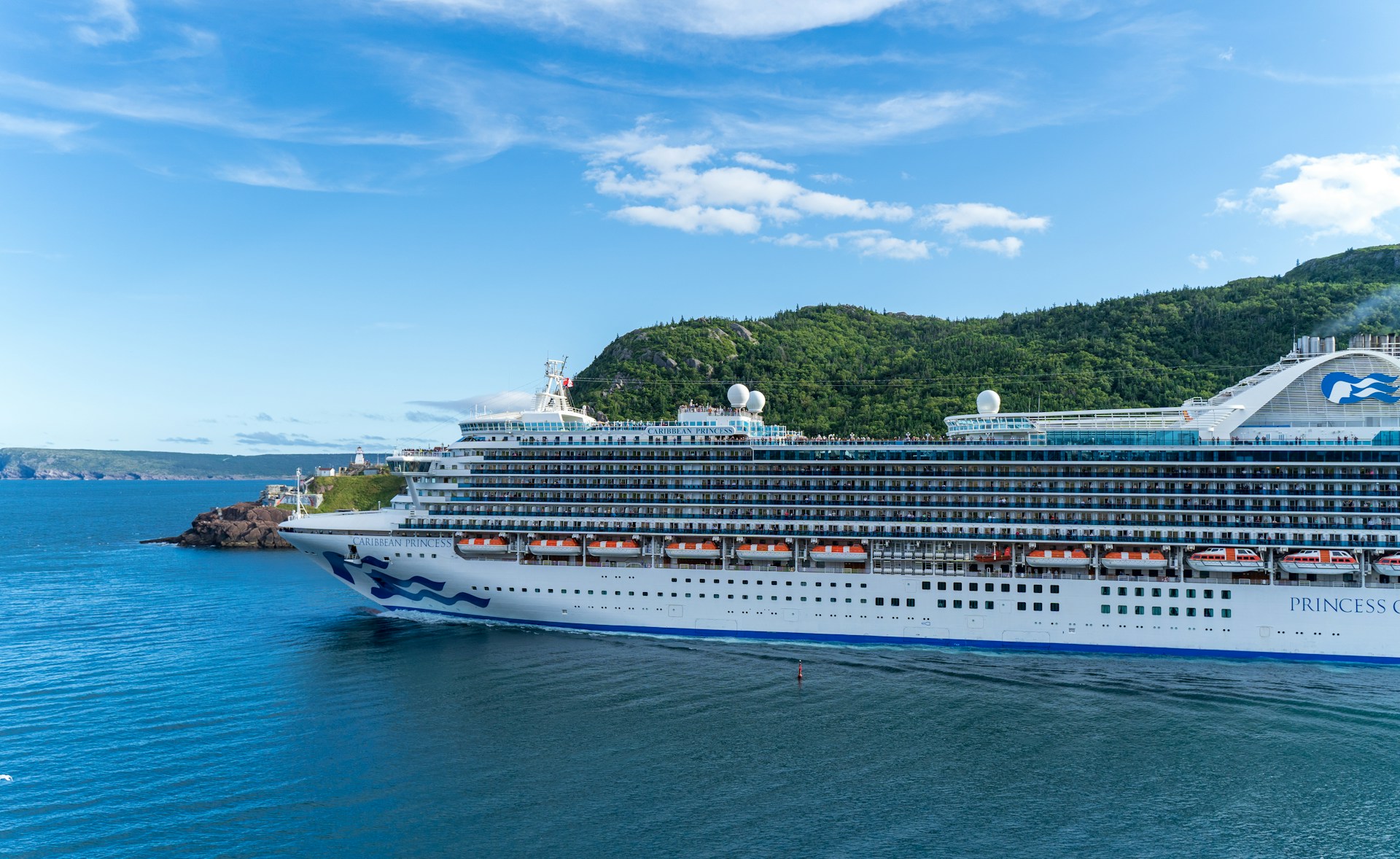 woman wearing yellow long-sleeved dress under white clouds and blue sky during daytime