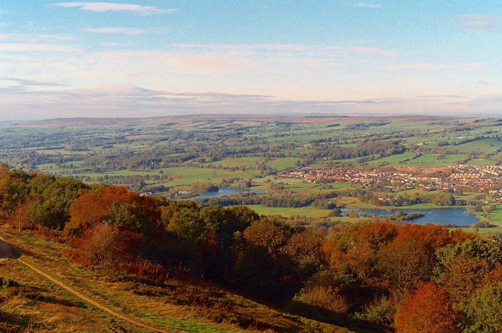 a scenic view of a town and a river from a hill