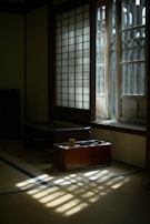 Softly blurred photo of a morning light filtering through shoji screens onto a clean desk.