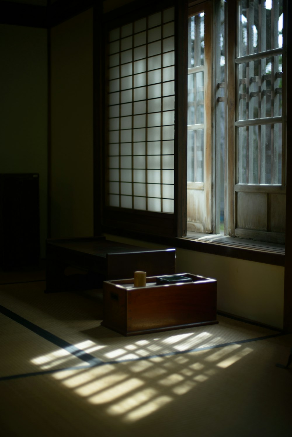 a box sitting on the floor in front of a window