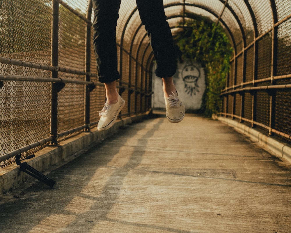 a person jumping in the air on a bridge