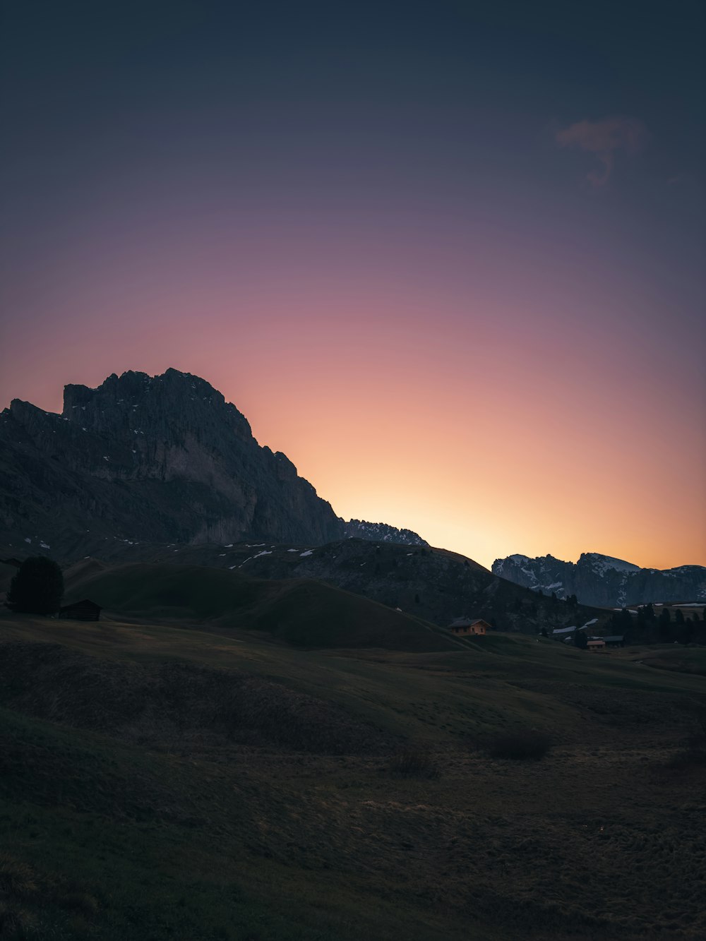 the sun is setting over a mountain range