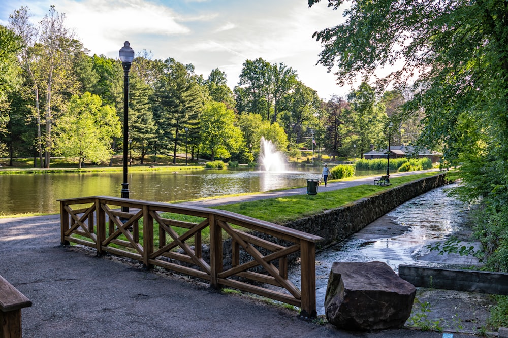 a wooden bench sitting next to a lake