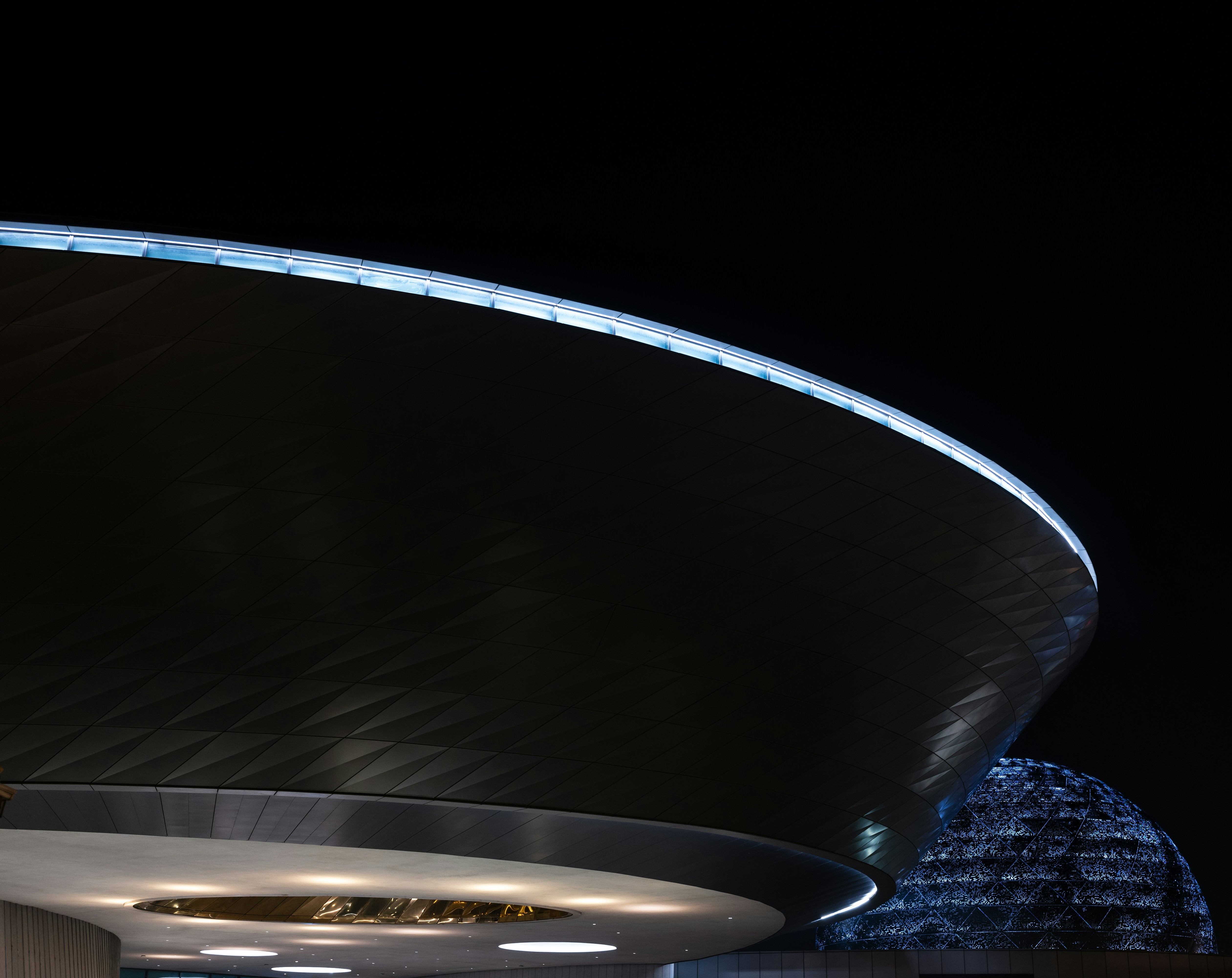 a building with a circular roof and a clock on it, Shanghai Astronomy Museum at night