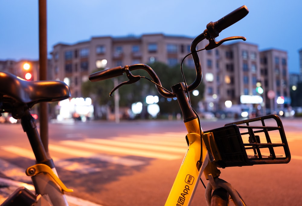 a yellow bicycle parked on the side of the road