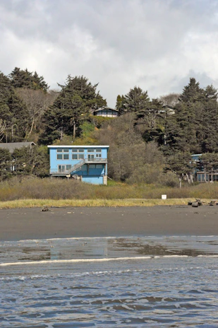 A panoramic view of a pristine North Vancouver Island home, its exterior vibrant and protected against coastal elements after recent painting.