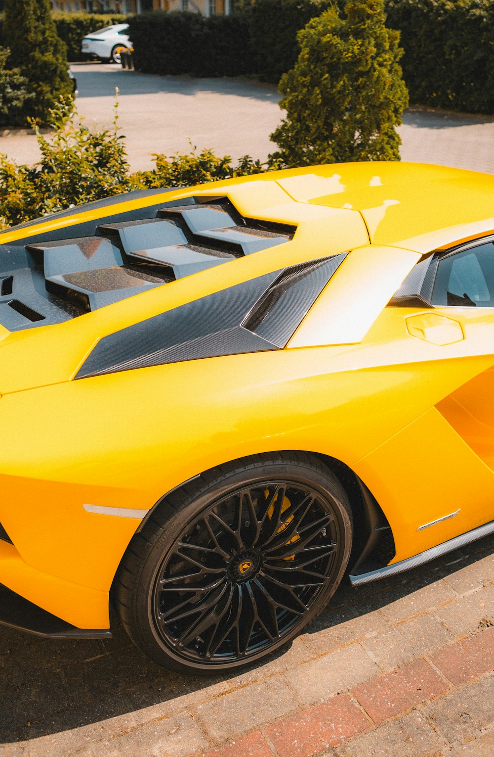 a yellow sports car parked in a driveway