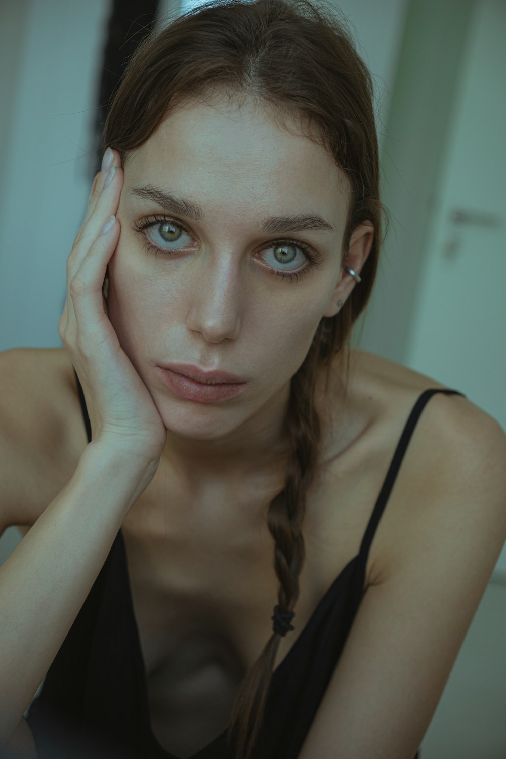 a beautiful young woman with blue eyes posing for a picture