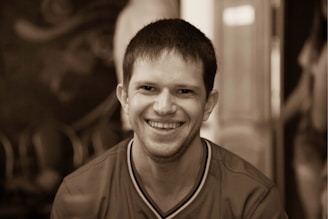 Portrait photo of a smiling team member in a casual office setting.