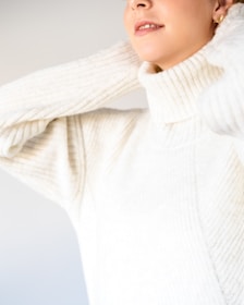 A close-up of a soft turtleneck sweater in deep navy.