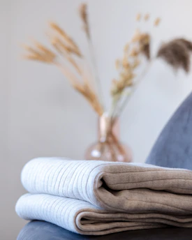 a stack of folded towels sitting on top of a table