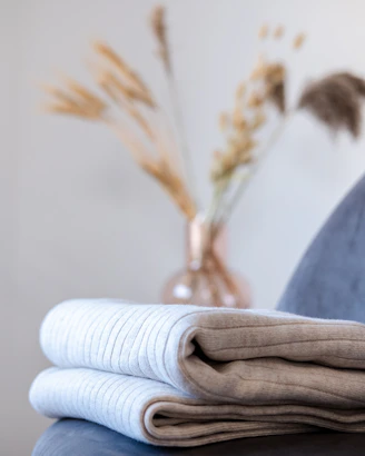 a stack of folded towels sitting on top of a table