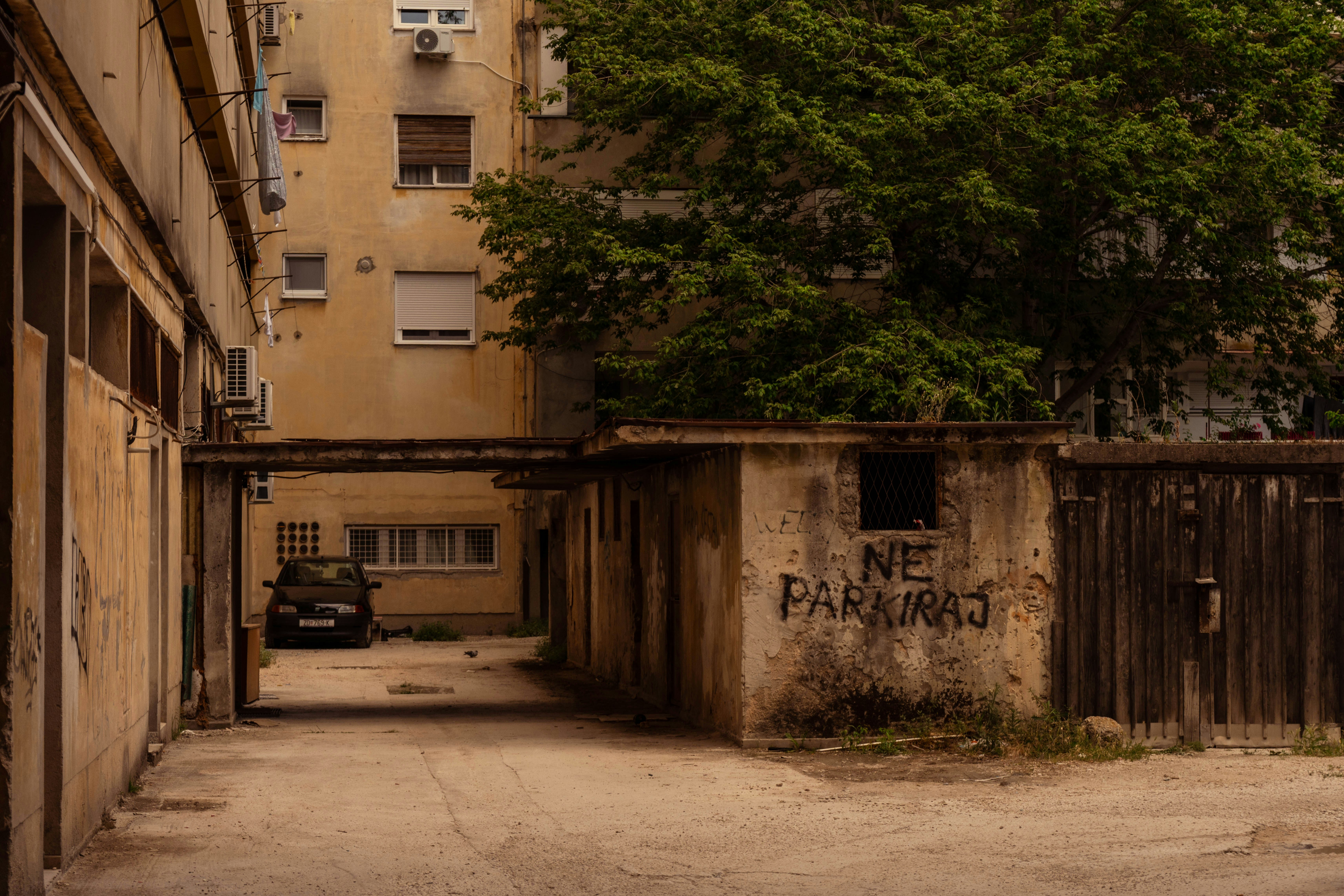an alley way with graffiti on the side of buildings